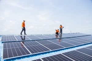 Professional Engineer Service Solar Panel. Worker Maintenance Cleaning Replacing Solar Panel. Solar photovoltaic panel system in Industry roof. Saving Energy with Clean Power.
